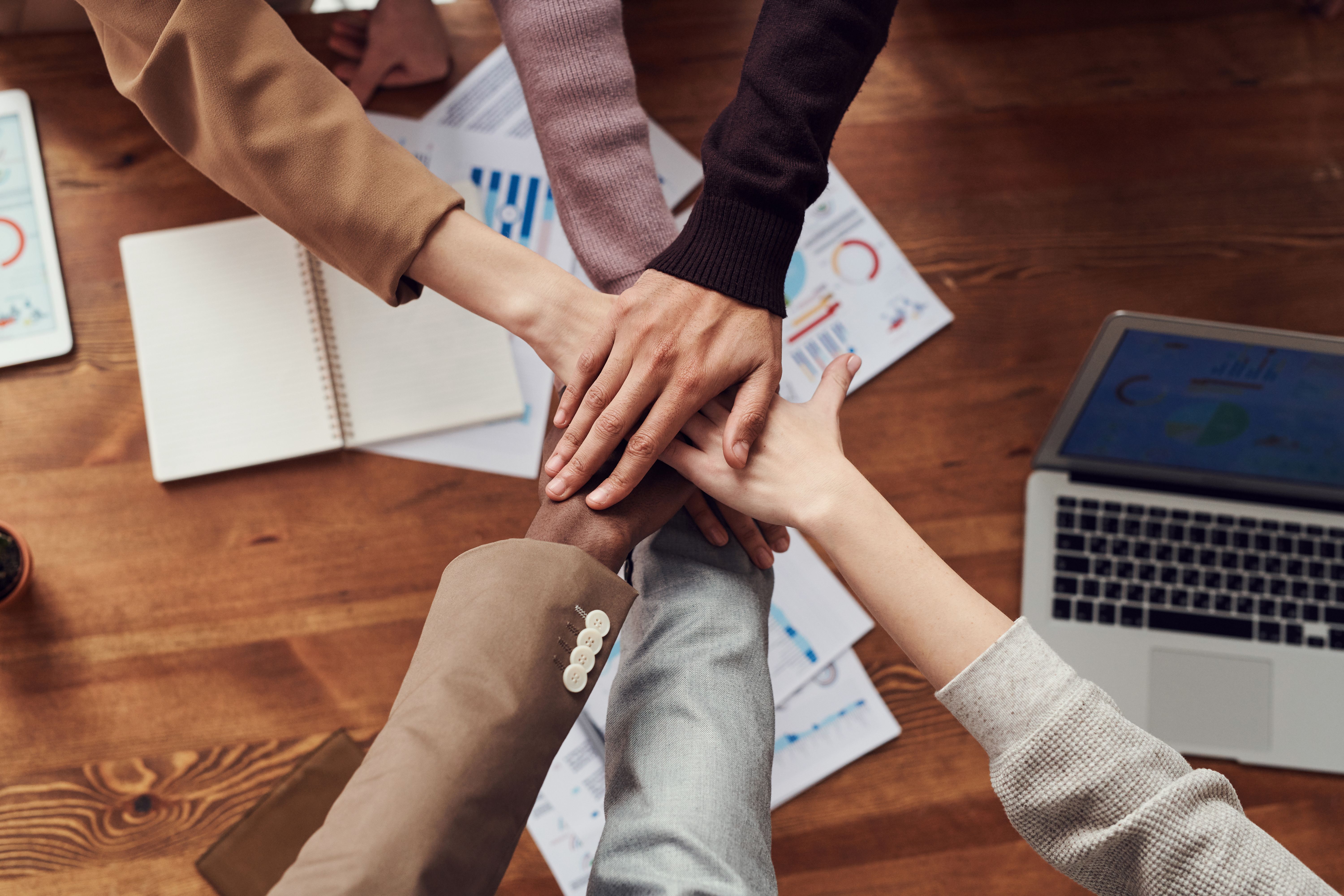 Educational professionals joining hands in partnership