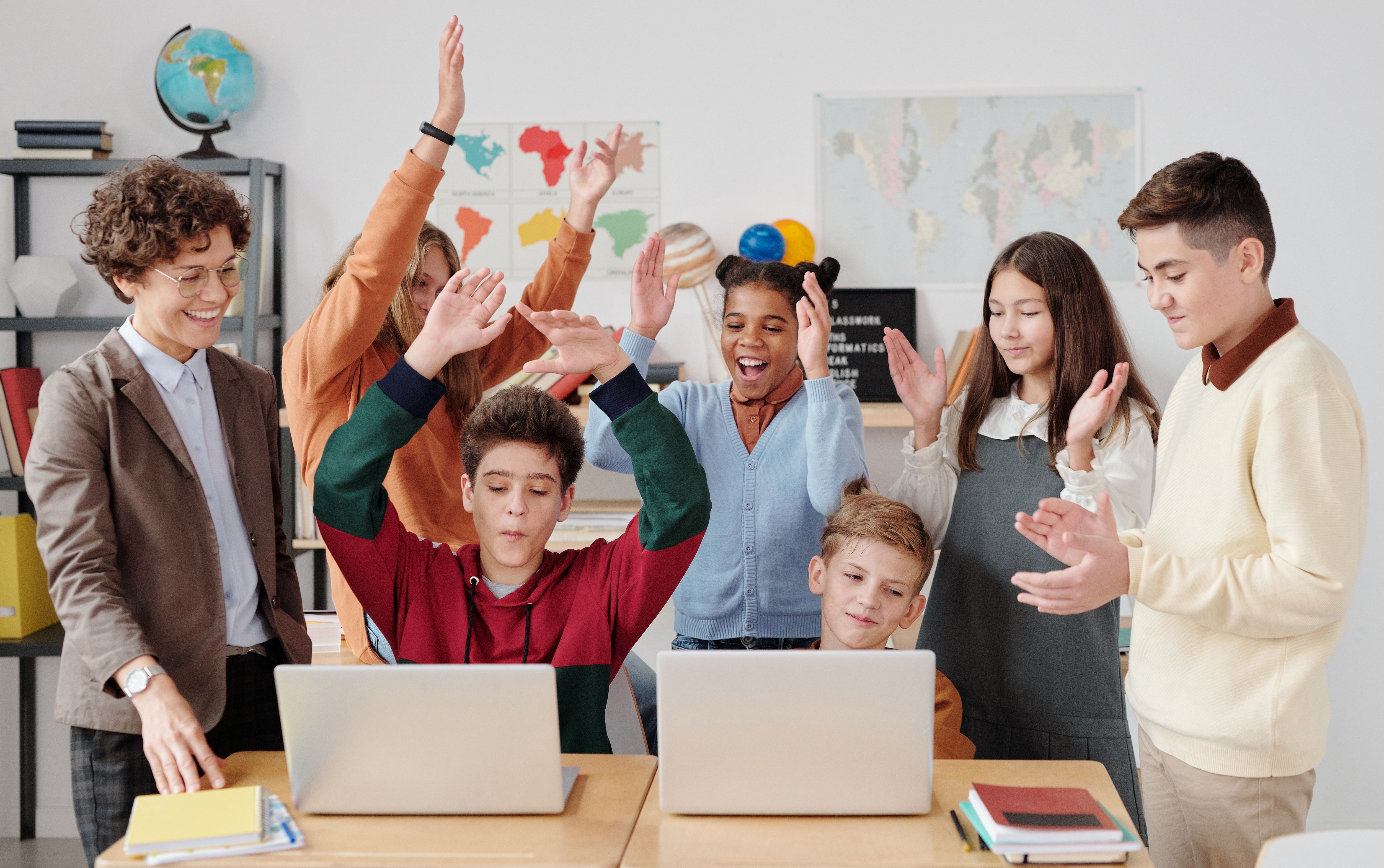 Teacher and students celebrating learning together